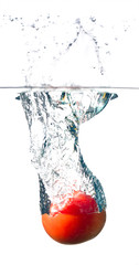 tomato splashing into water isolated on white background