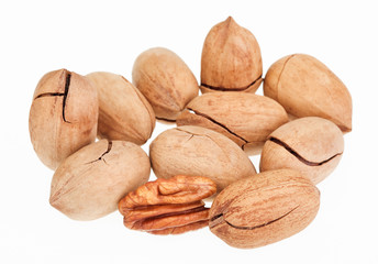 Many pecan nuts isolated on white, one cracked