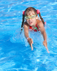 Child swim  in swimming pool.