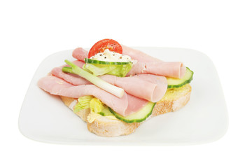 Open ham sandwich on plate