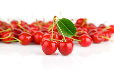 fresh cherry fruits with green leaves