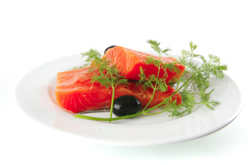 smoked salmon on white plate with olives