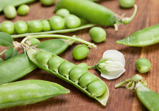 Green peas on wood board