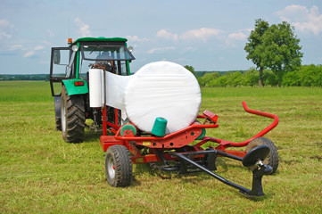 Way of gathering of hay in rolls