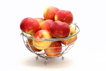 Red apples in metal basket on white background