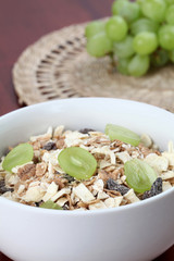 Granola with dried fruits garnished with fresh grapes