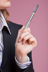 Businesswoman gesturing with pen