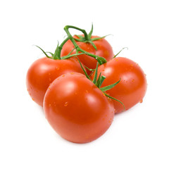 Red tomatoes on the green branch.