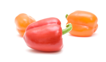 three sweet red and orange peppers; isolated on white background
