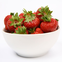 Strawberries in a bowl on white background
