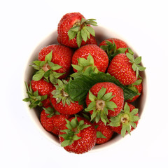 Strawberries in a bowl on white background