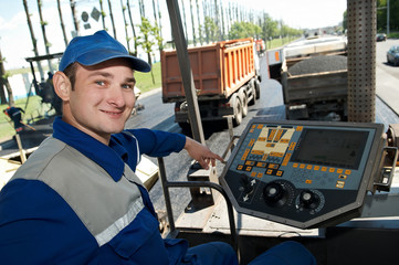 Young paver worker at asphalting works