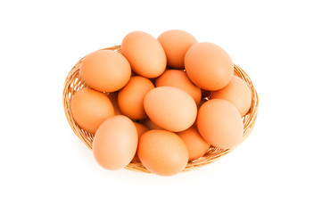 Brown eggs in the basket on white