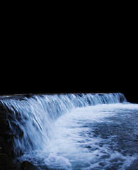 A large river waterfall in the dark. Copyspace