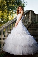 Fototapeta premium Bride posing on old stairs