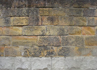 very old worn dirty orange brown large stone wall