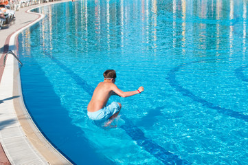 teenager swims in pool