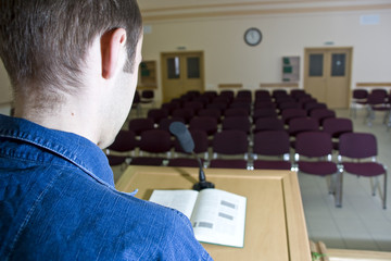 Speaker at work and empty auditorium