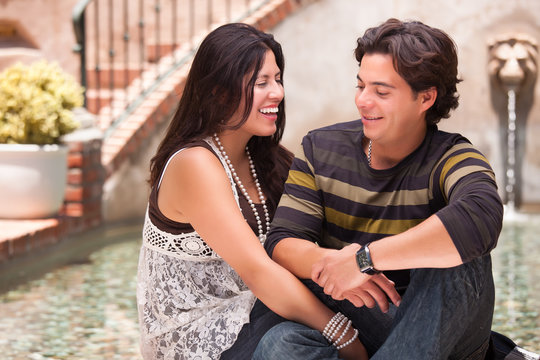 Attractive Hispanic Couple At A Fountain