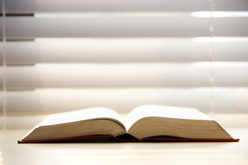 Isolated open book on of the table .