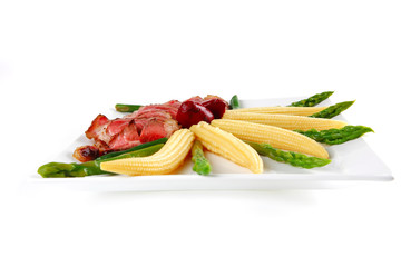 meat served on white with corns