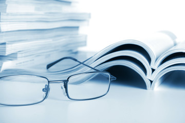 Open journals with glasses