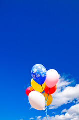 Colorful balloons against sky