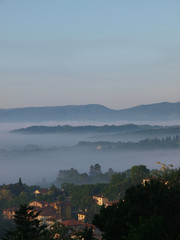 Fabulous landscape of the foggy morning in Tuscany.