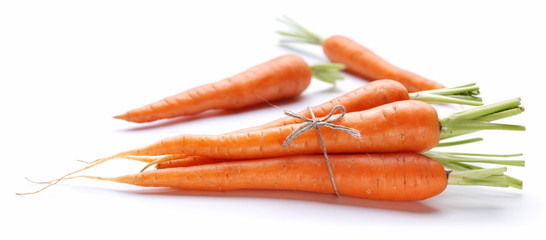 Ripe fresh carrots on a white background.