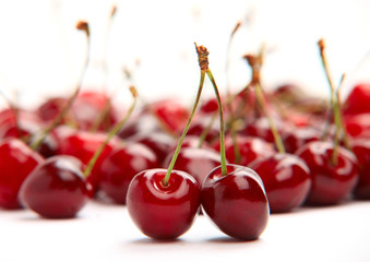 Ripe red cherries on white background