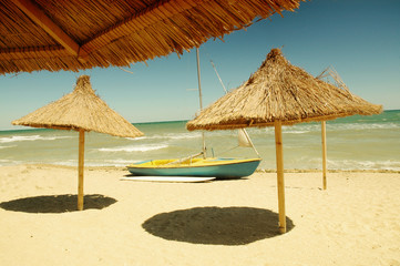 Beach umbrella and a boat