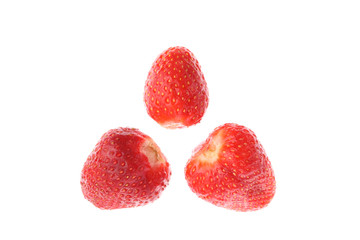 Three red juicy ripe strawberries isolated on white