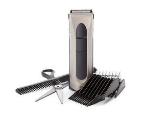 Clipper, comb and scissors on white background