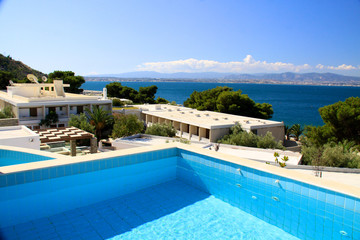 beautiful swimming pool surrounded by chairs and flowers