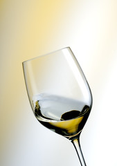 A Glass of white wine in an yellow ambiance