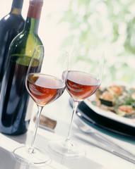 Glasses of Wine with two bottles