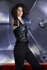 Naklejka premium Female Criminal threatening in front of bank vault