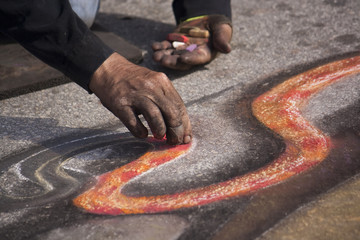 a man painting chalk art © Reicaden