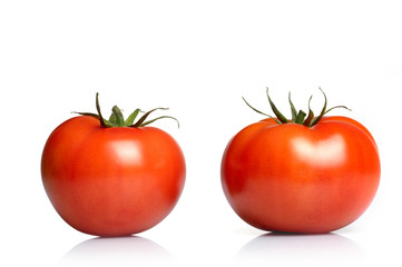 Two tomatoes isolated on white background