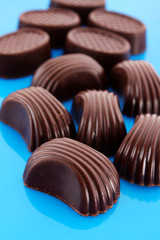Assorted chocolate candies on blue background
