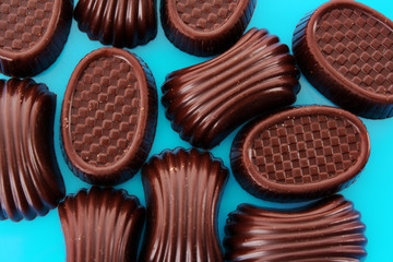 Assorted chocolate candies on blue background