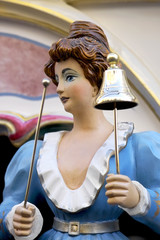 Decorated female figure on a hurdy gurdy