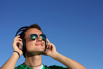 Portrait of a cute blond in glasses with headphones