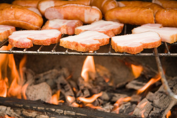 Bacon and sausages on barbeque
