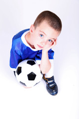Kneeling boy with soccer ball