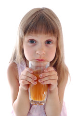 Little girl holds glass of  juice.