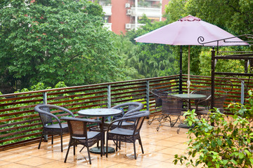 Patio rattan chairs and table  in raining