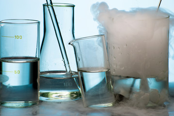 Laboratory glassware during experiment with vapor eruption
