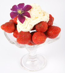 Strawberries with whipped cream and clematis flower