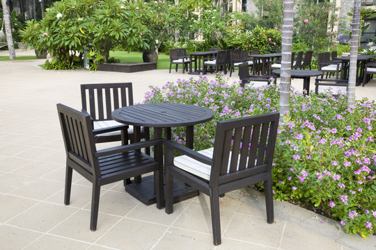 pation with chairs and tables in the garden